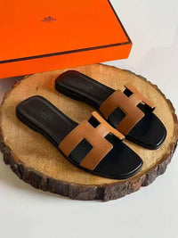 Hermès Oran Leather Sandal in Brown with Black Sole
