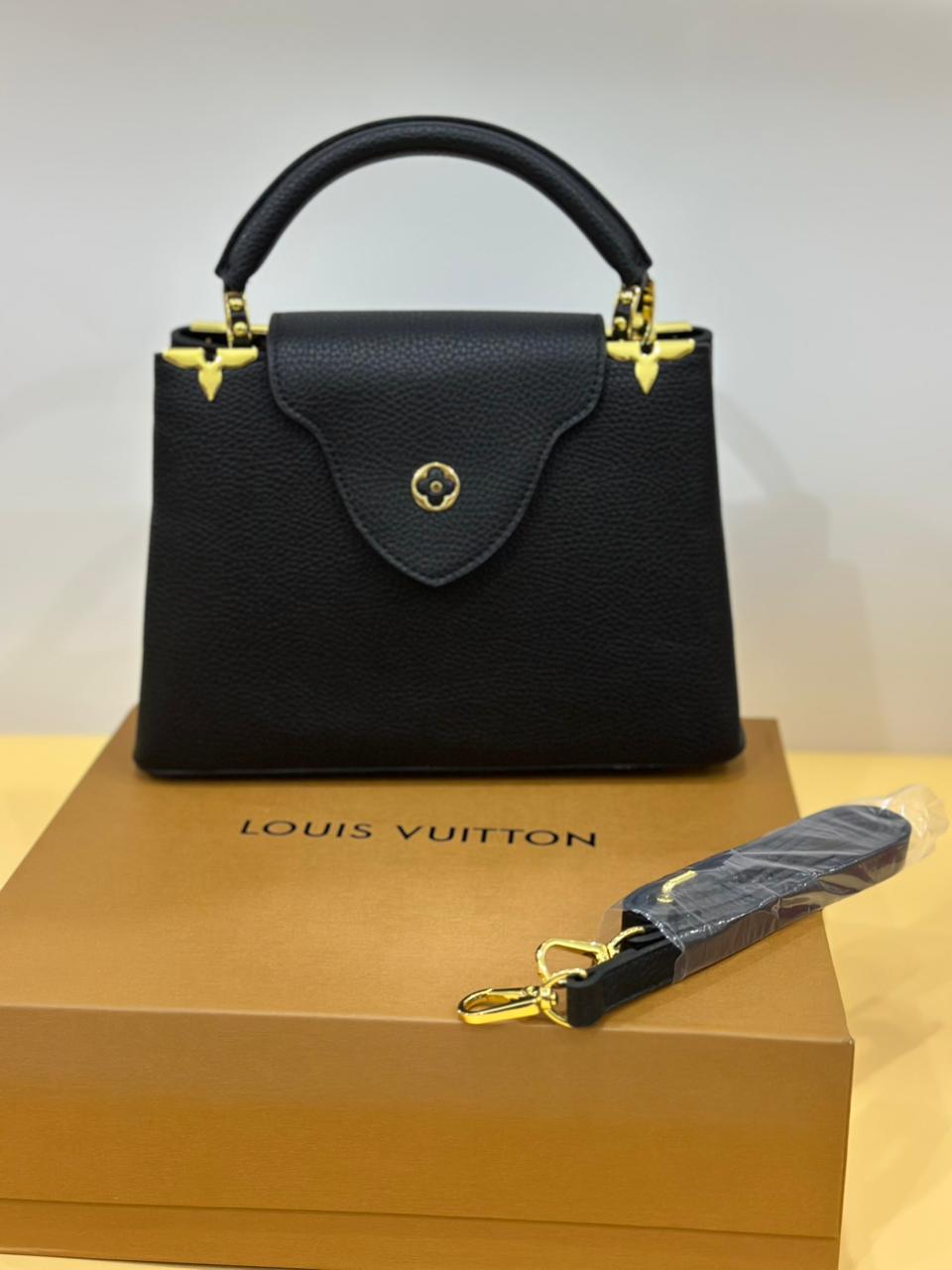 Model carrying Louis Vuitton designer bag – statement women’s fashion accessory perfect for upscale everyday style.